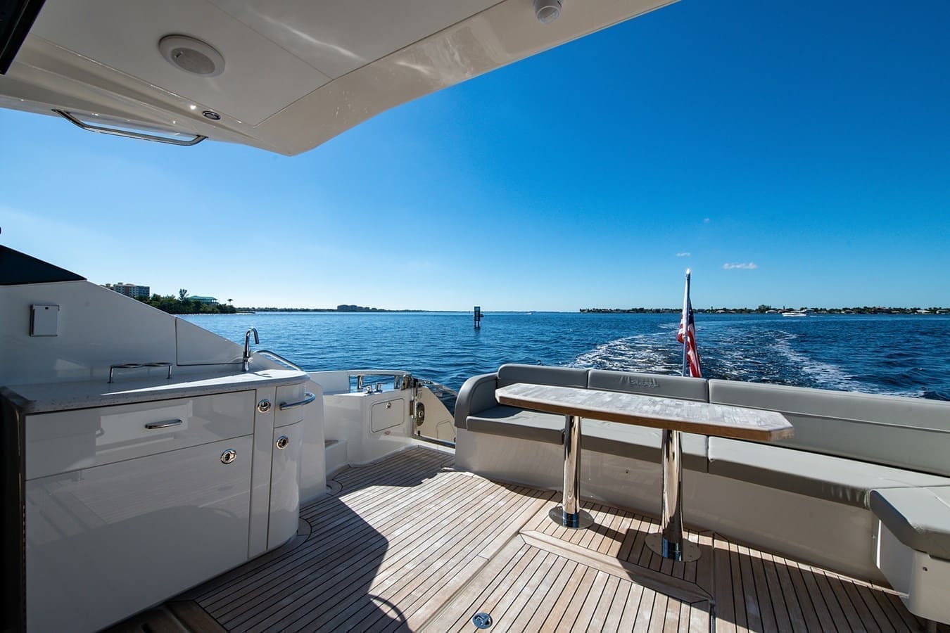 Teak aft deck with wet bar and open water beyond