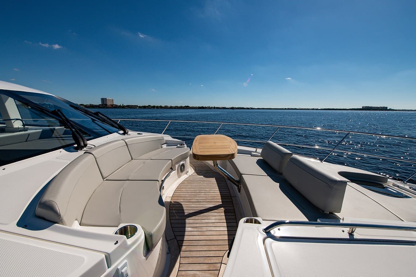Curved bow seating with drink holders and sun on the water