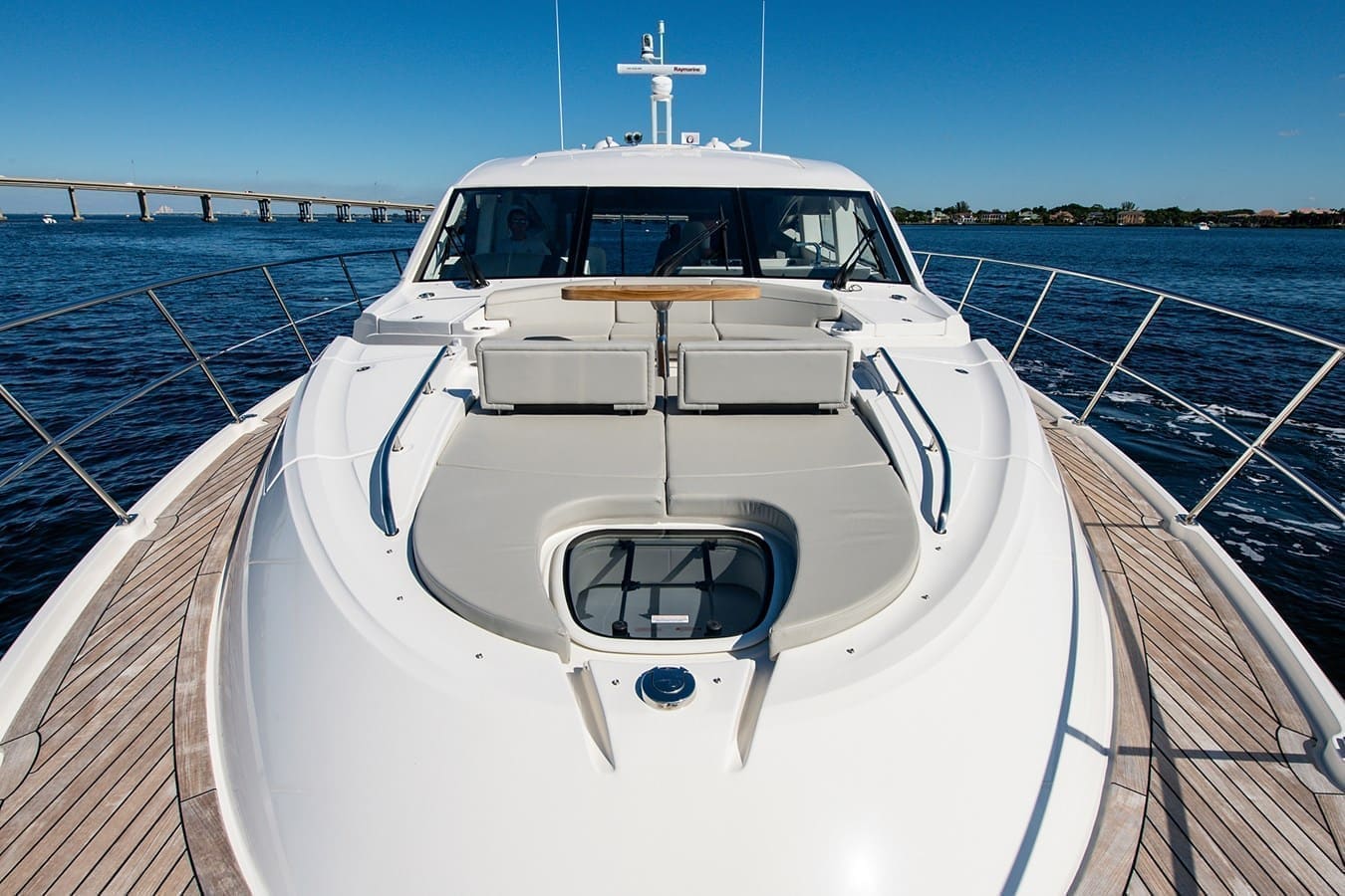 Forward sunpads and anchor windlass seen from the bow rail