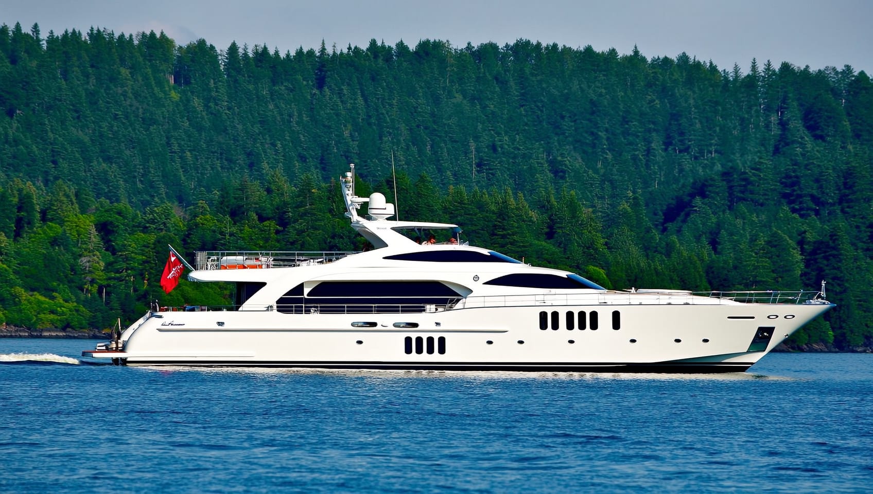 The L-Class 650 luxury yacht cruising past a green shoreline