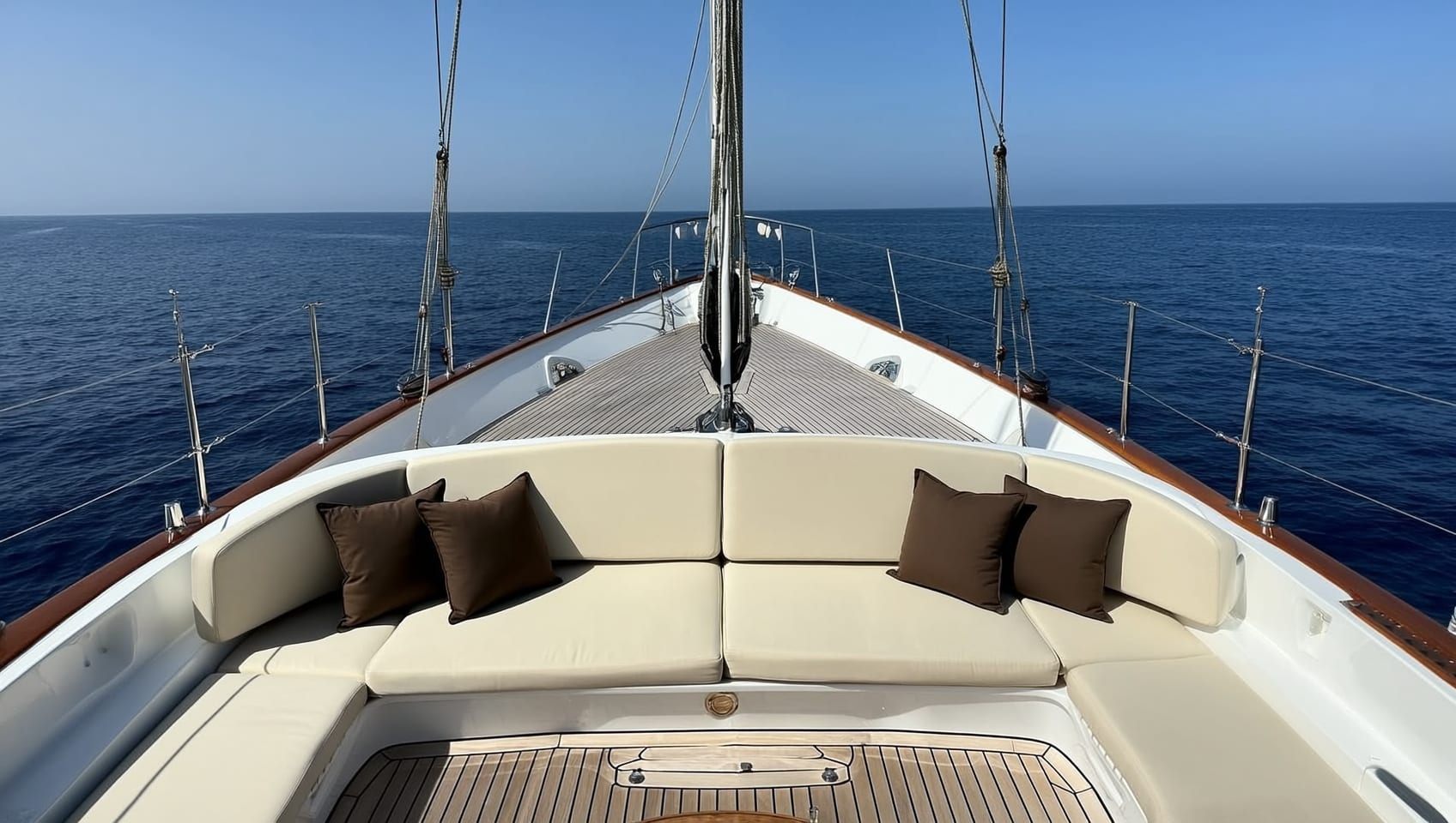 Shaded aft cockpit lounge with sunpads overlooking the sea