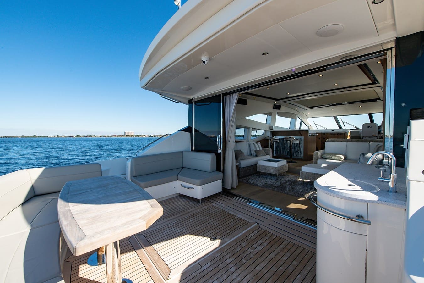 Aft deck seating opening into the salon with a wet bar