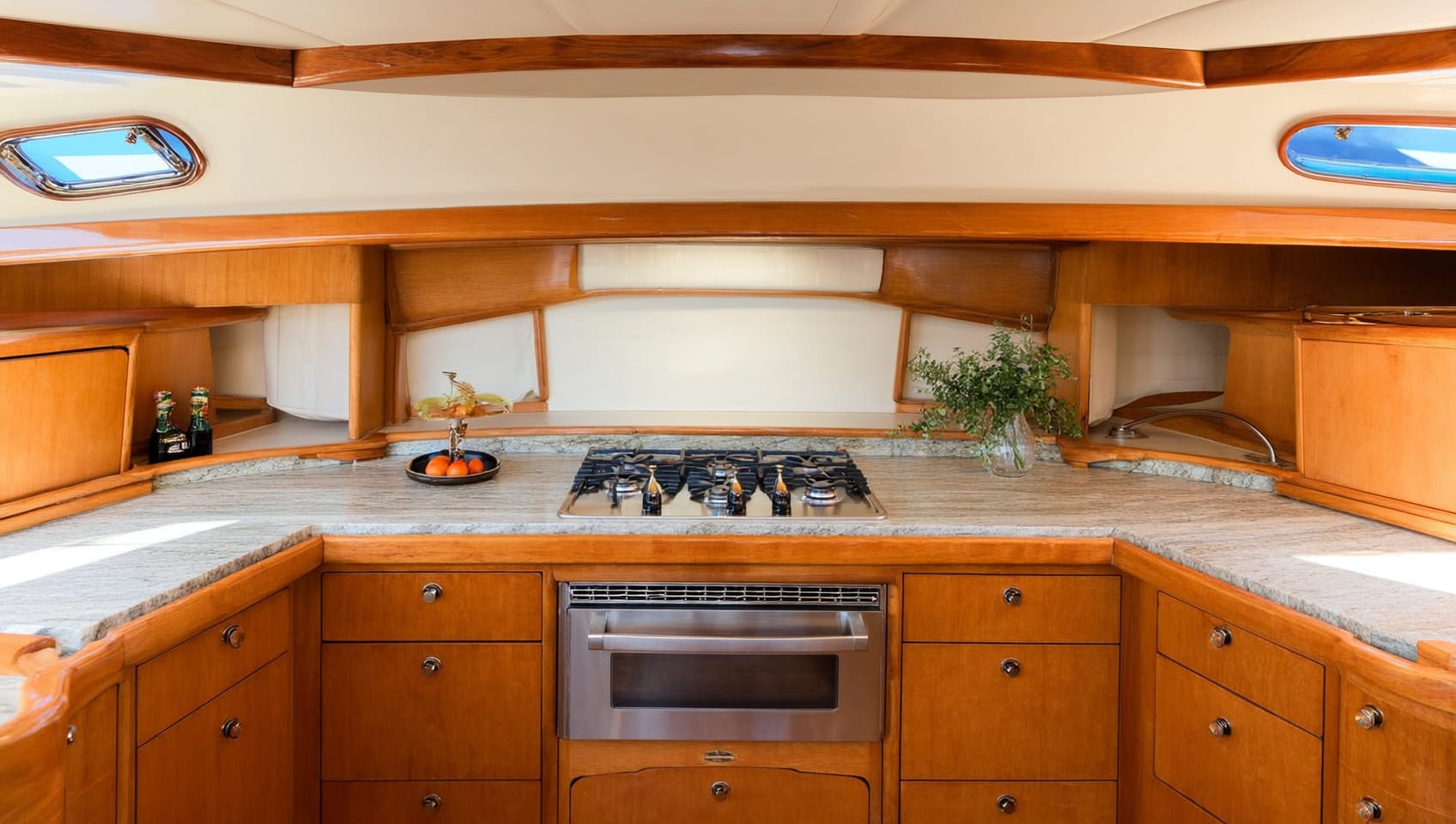 Fully equipped galley with stone counters and teak cabinetry