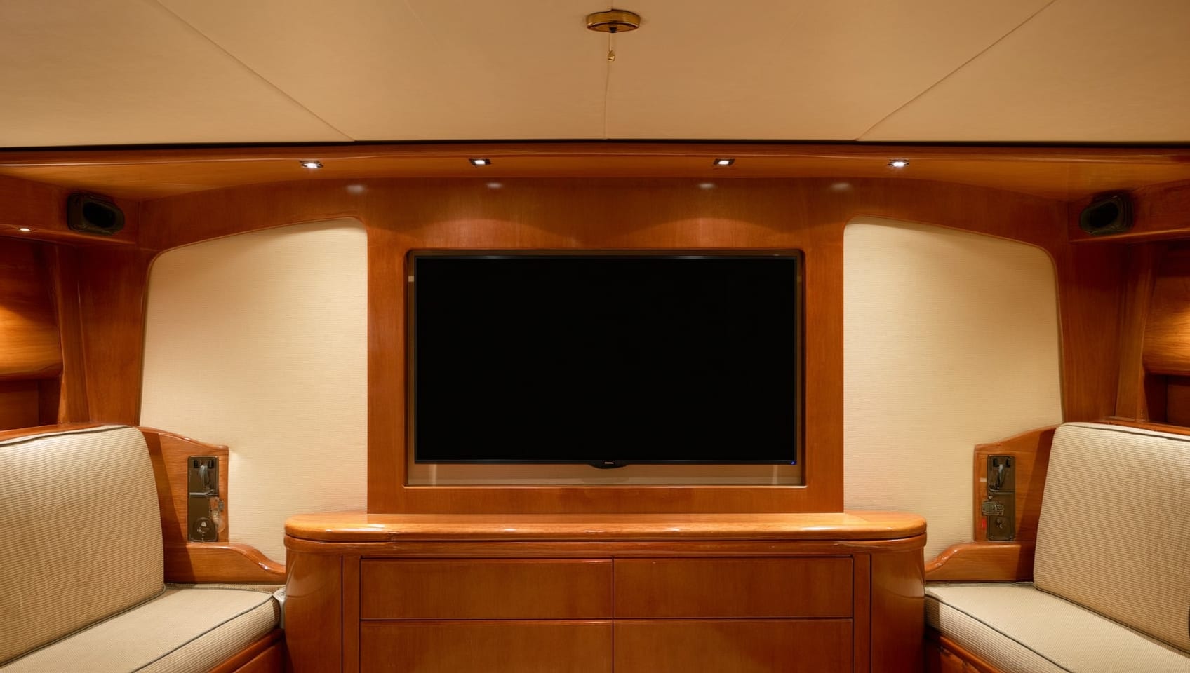 Guest stateroom with twin berths and warm accent lighting