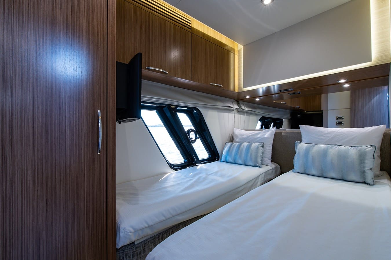 Guest stateroom with twin berths and a window to the water