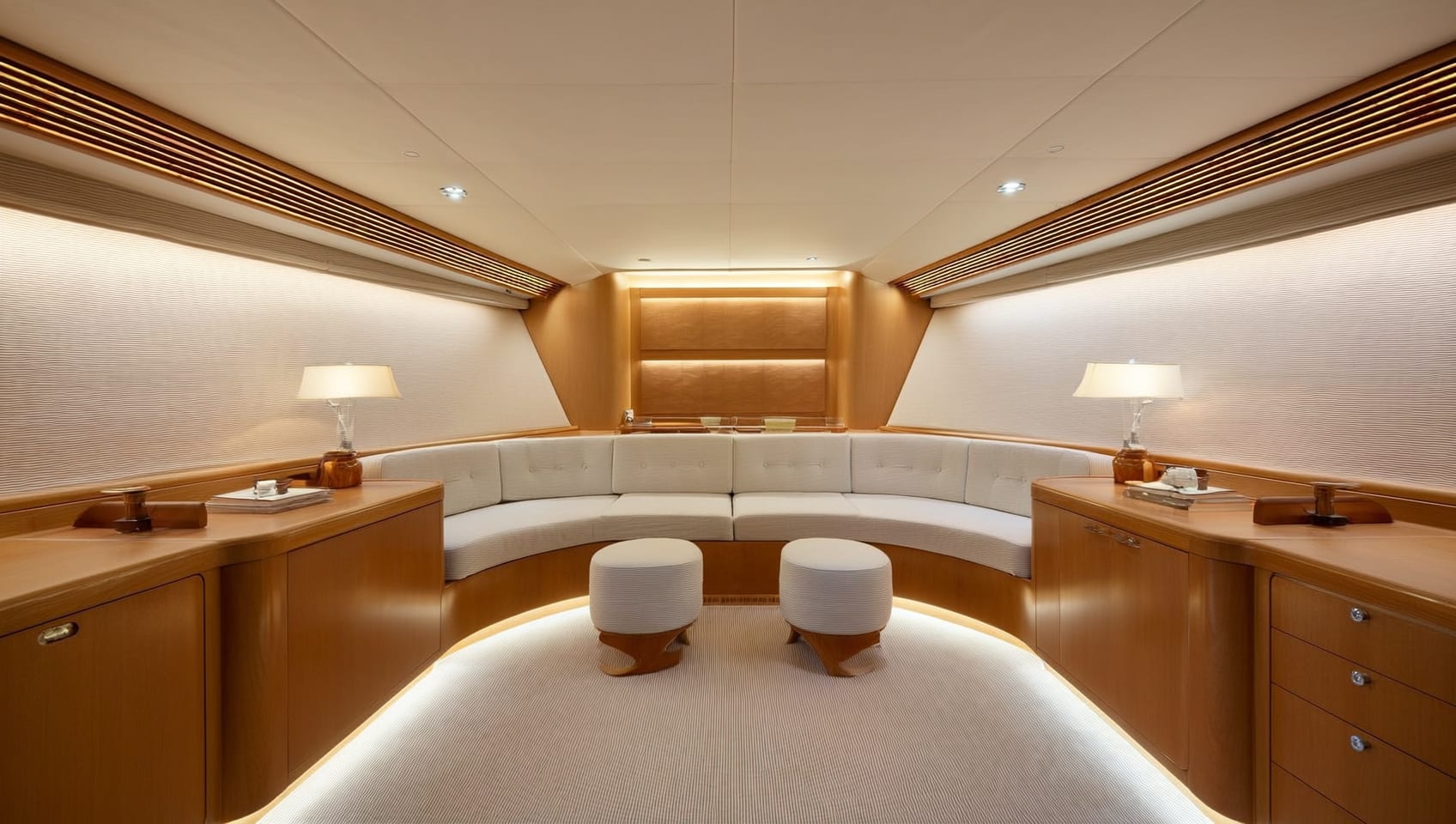 Master stateroom with padded headboard and lounge seating